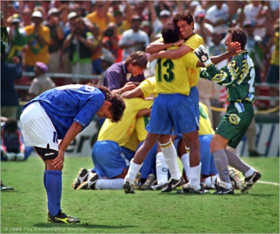 Roberto Baggio after missing a penalty kick. Brazil celebrates in the background. 